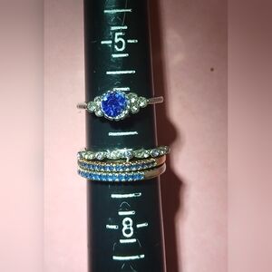 4 Elegant Woman's Rings.  3 Size 7 Ring Bands And 1 Size 6 Blue Stone Ring.